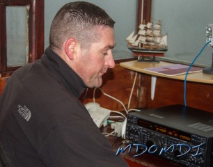 Ross Bane (GM1KNP) checking the bands at the shack at Scarlett Point, Isle of Man.