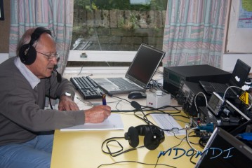 Walter Sins (DJ4AK) working on the radio and logging on paper