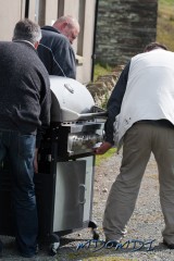 The guys moving the BBQ to a suitable spot