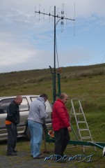Guenther (DG1SBU) puts the finishing touches to the feeder whilst Erwin (DL6SBN) and Peter (DL1SPH) check over the installation.