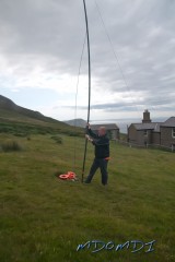 Erwin Kleiner (DL6SBN) putting up the poles that will hold the loop antenna in place.