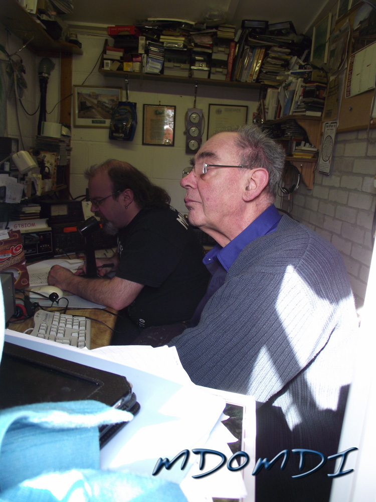 James (MD0MDI) working the radio with Mike (GD4WBY) entering on the logbook.