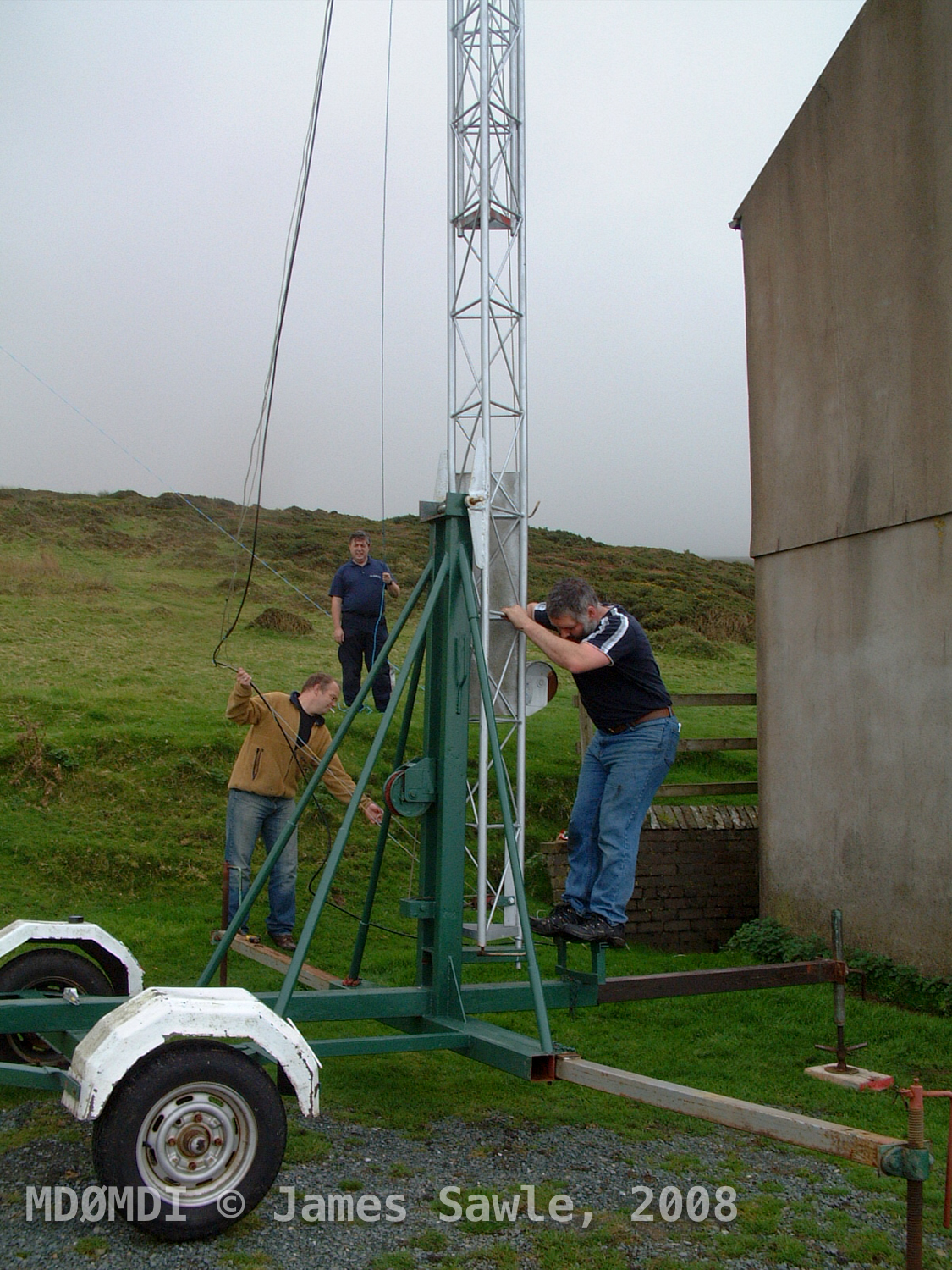 With the mast upright, Matty checks that all the guy lines are not tangles up and that she is ready to be raised.