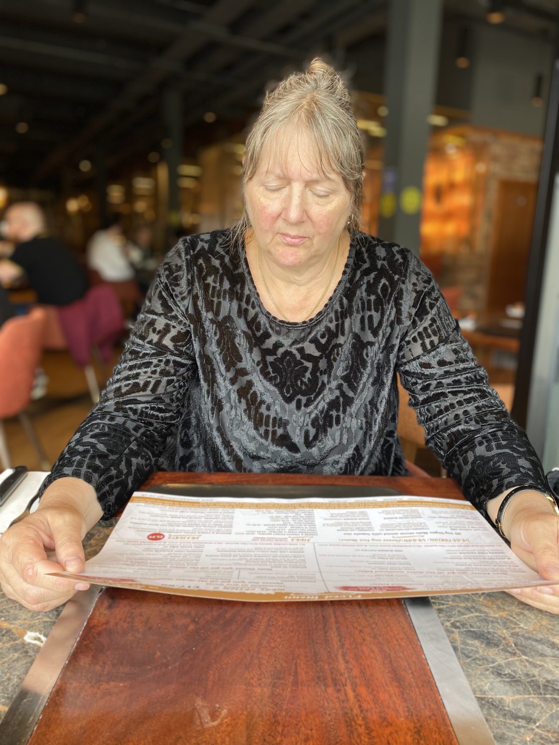 Sue Delduca looking through the menu