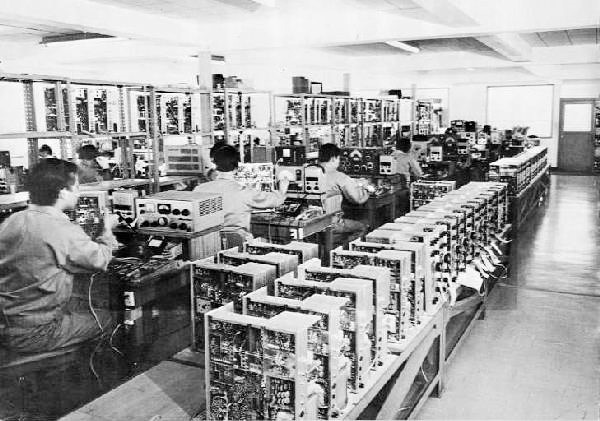 Yaesu Assembly Line with lines of early FT-101's being checked over.