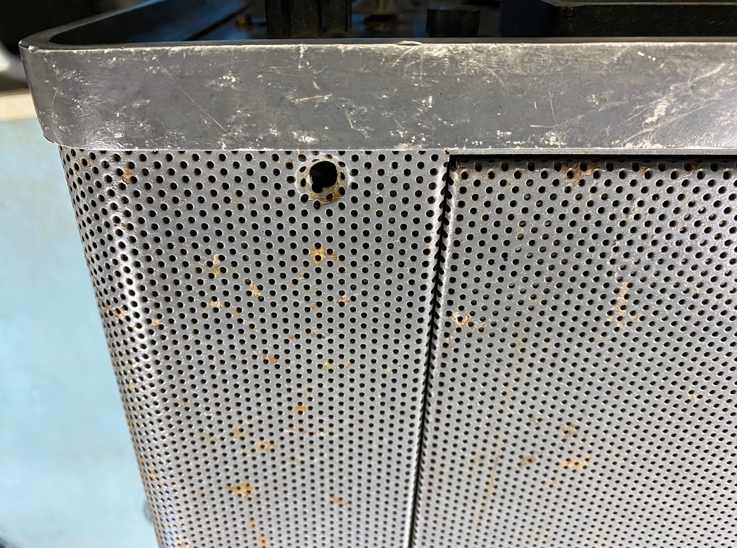 Either side of the lid opening are holes where something was possibly installed to.