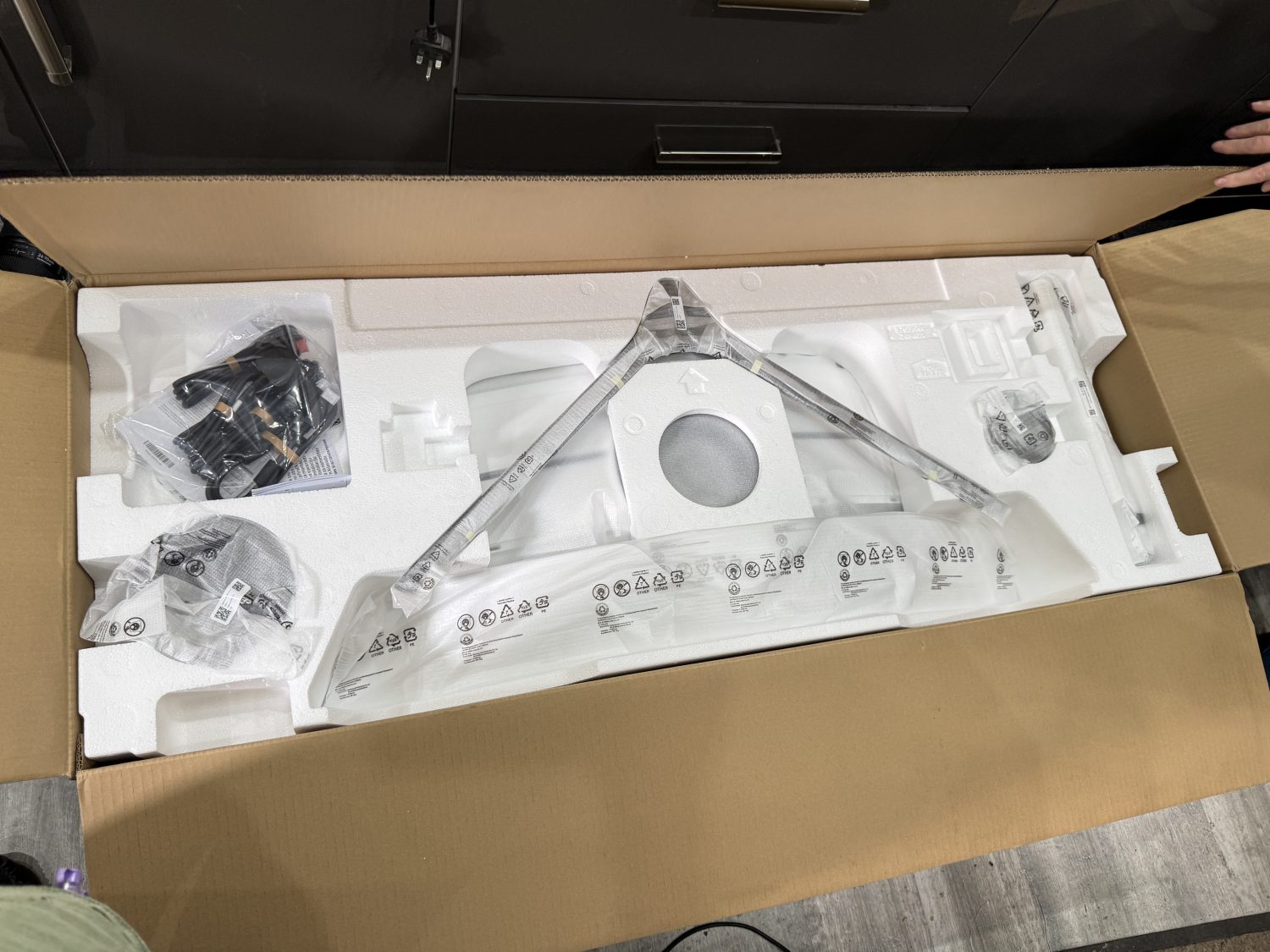 The contents of the box that holds the Samsung 57" G95NC Odyssey Neo G9 240Hz Dual UHD Monitor