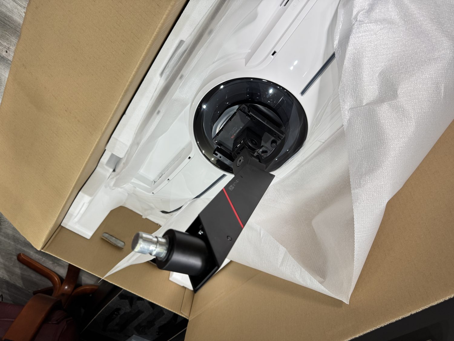The Top section of the arm, complete with the quick release plate is installed to the back of the monitor, this will help to life the monitor out of the box.